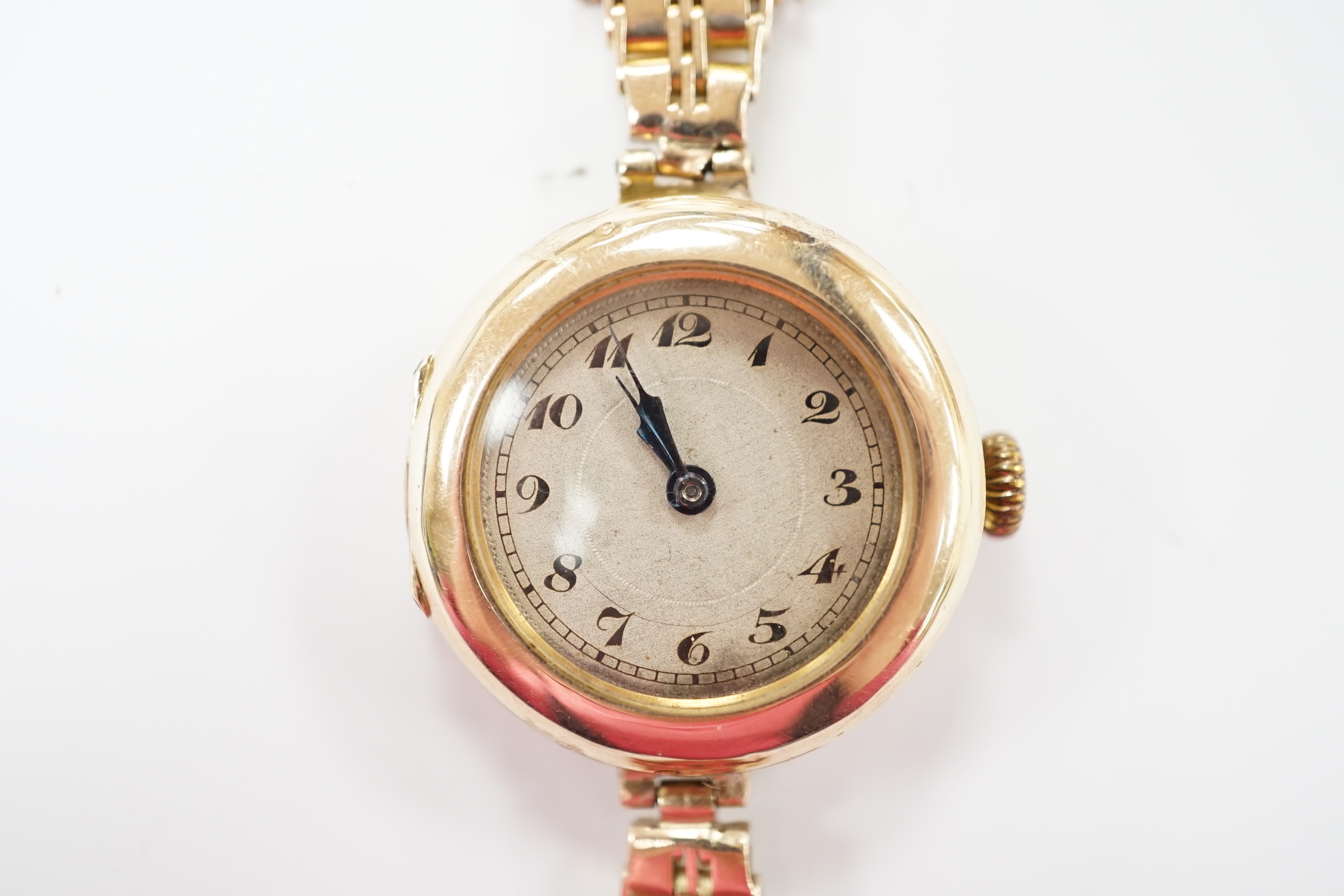 A lady's early to mid 20th century 9ct gold manual wind wrist watch(a.f.), on a yellow metal bracelet